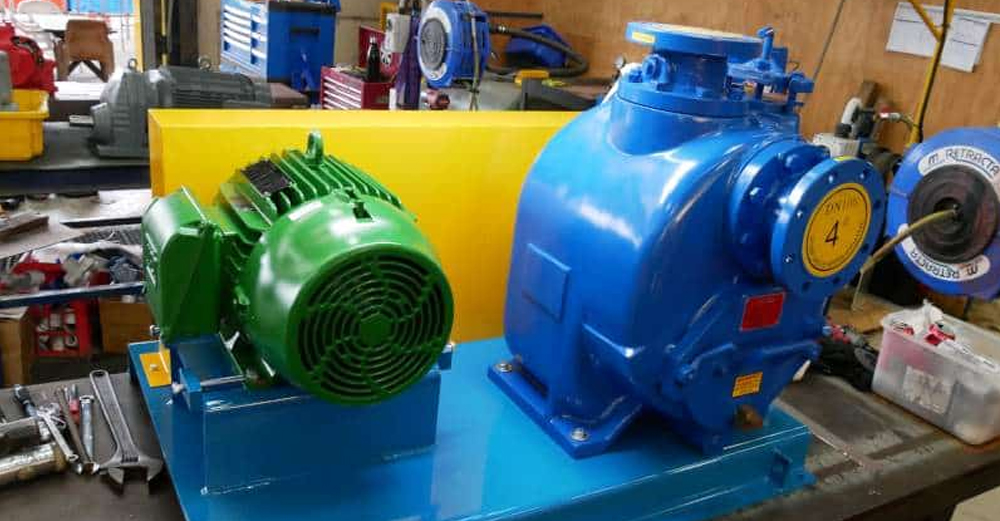 Large industrial self-priming centrifugal pump and electric motor assembled on a base plate for dam dewatering and construction site fluid transfer applications