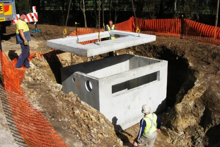 Concrete pump chamber being installed beside water