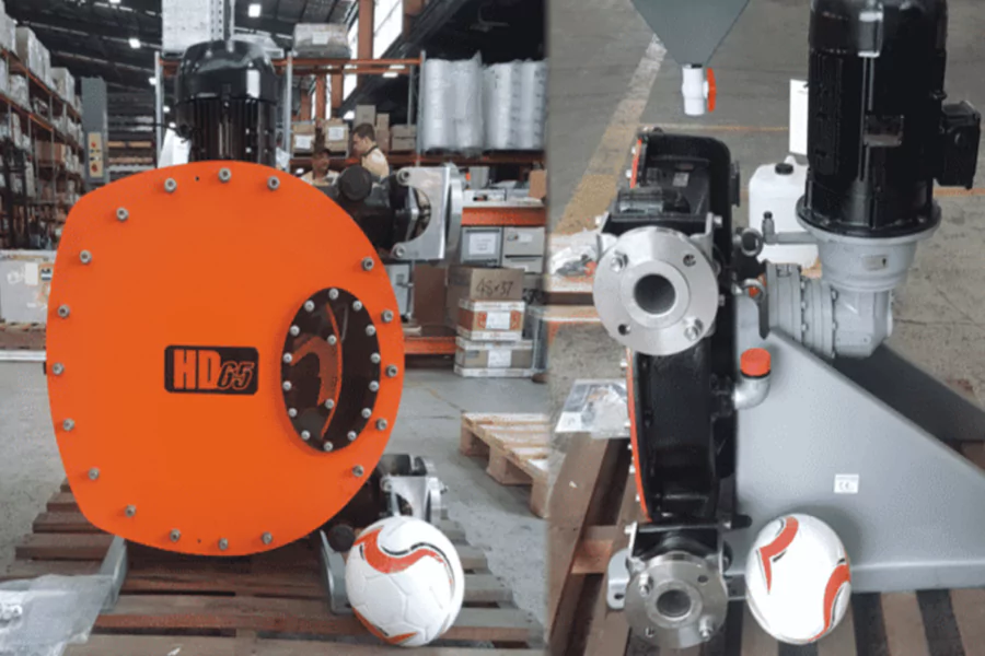 Orange industrial pump component in a workshop