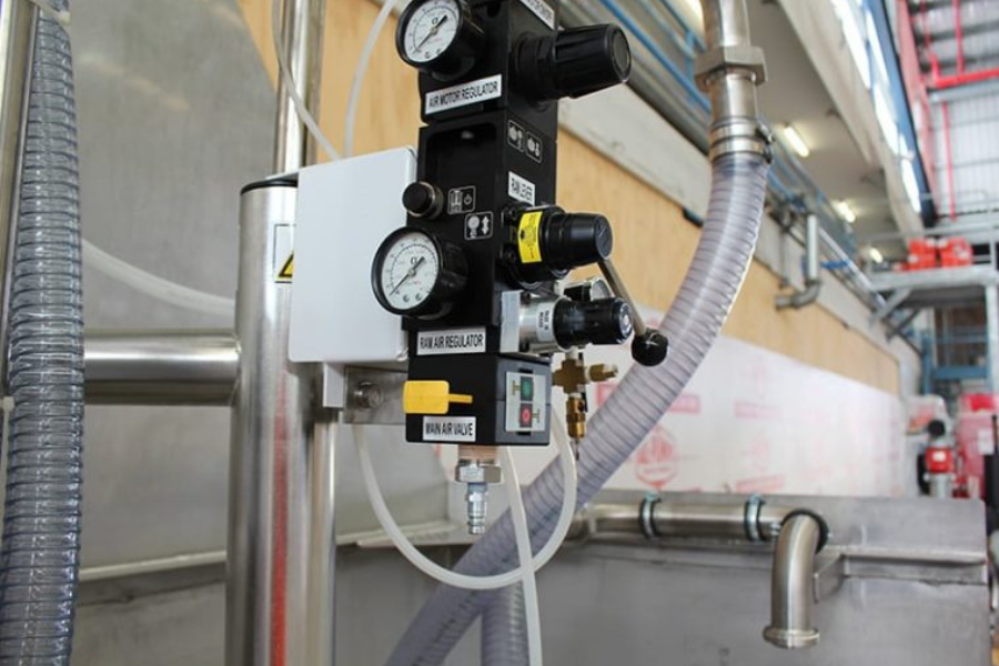 Pressure gauge and control fittings on industrial equipment