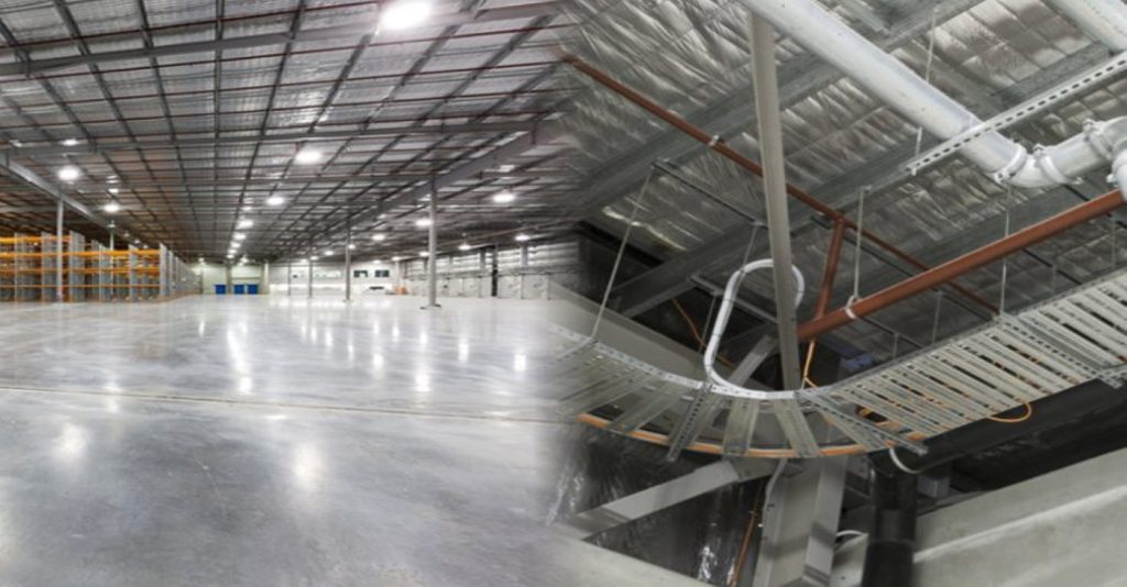 Split view of the Aldi Brendale industrial warehouse facility, showing the vast empty floor space and complex ceiling pipework and cable trays for industrial plumbing systems