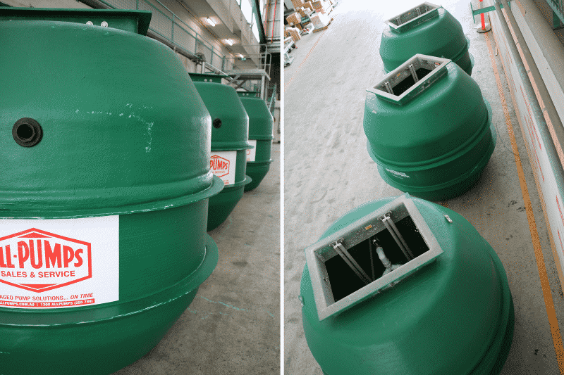 Multiple green fiberglass sewage pump station (wet well) chambers with exposed manway covers, ready for installation in wastewater management and municipal infrastructure projects
