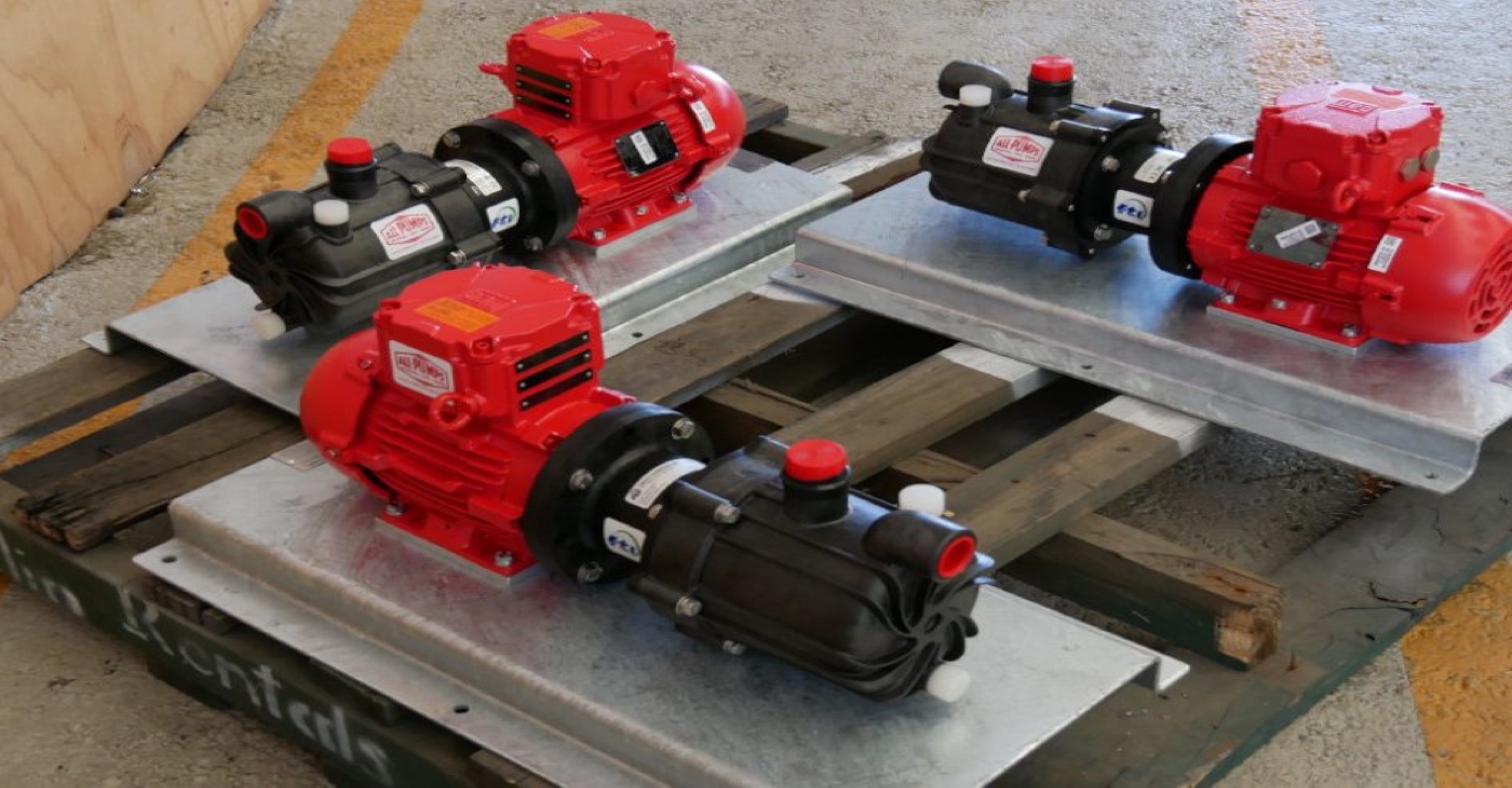 Three packaged Finish Thompson SP Series self-priming polypropylene pumps with red motors, used for corrosive chemical transfer and durable acid handling in industrial environments; supplied by all-pumps