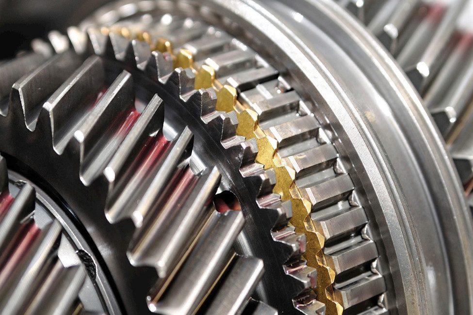 Close-up detail of heavy-duty industrial gears in a Tuthill lubrication or gear pump, designed for high-pressure industrial fluid transfer and heavy machinery systems