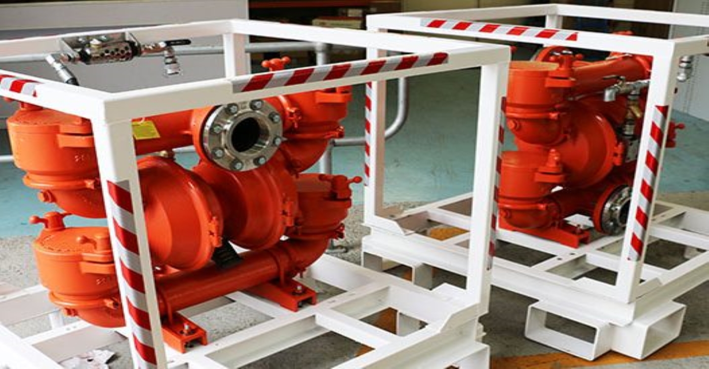 Two Wilden T20 Air-Operated Double Diaphragm (AODD) pumps with cast iron wetted parts, mounted in protective white and red safety frames for heavy-duty slurry and chemical transfer