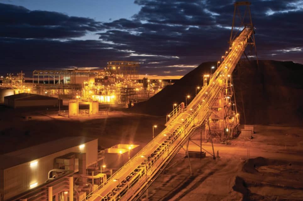 Large-scale mining operation infrastructure, showing a vast site with processing equipment and fluid handling systems for ore extraction and slurry management