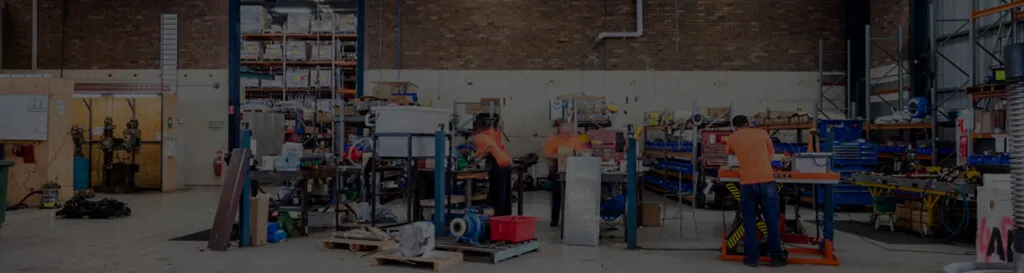Interior of the All Pumps Sales & Service industrial workshop where technicians service and repair heavy-duty pumps, motors, and industrial machinery components