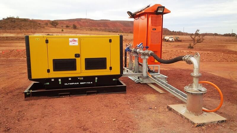 Complete mine dewatering bore pump setup in a reddish-brown mining environment, featuring a yellow Olympian GEP110-4 diesel generator and an orange pump control panel