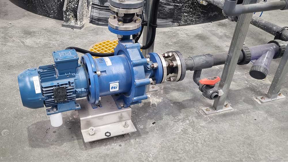 Blue Finish Thompson (FTI) DB Series magnetic drive centrifugal pump installed in a chemical plant, used for leak-free transfer of corrosive and hazardous fluids in chemical processing