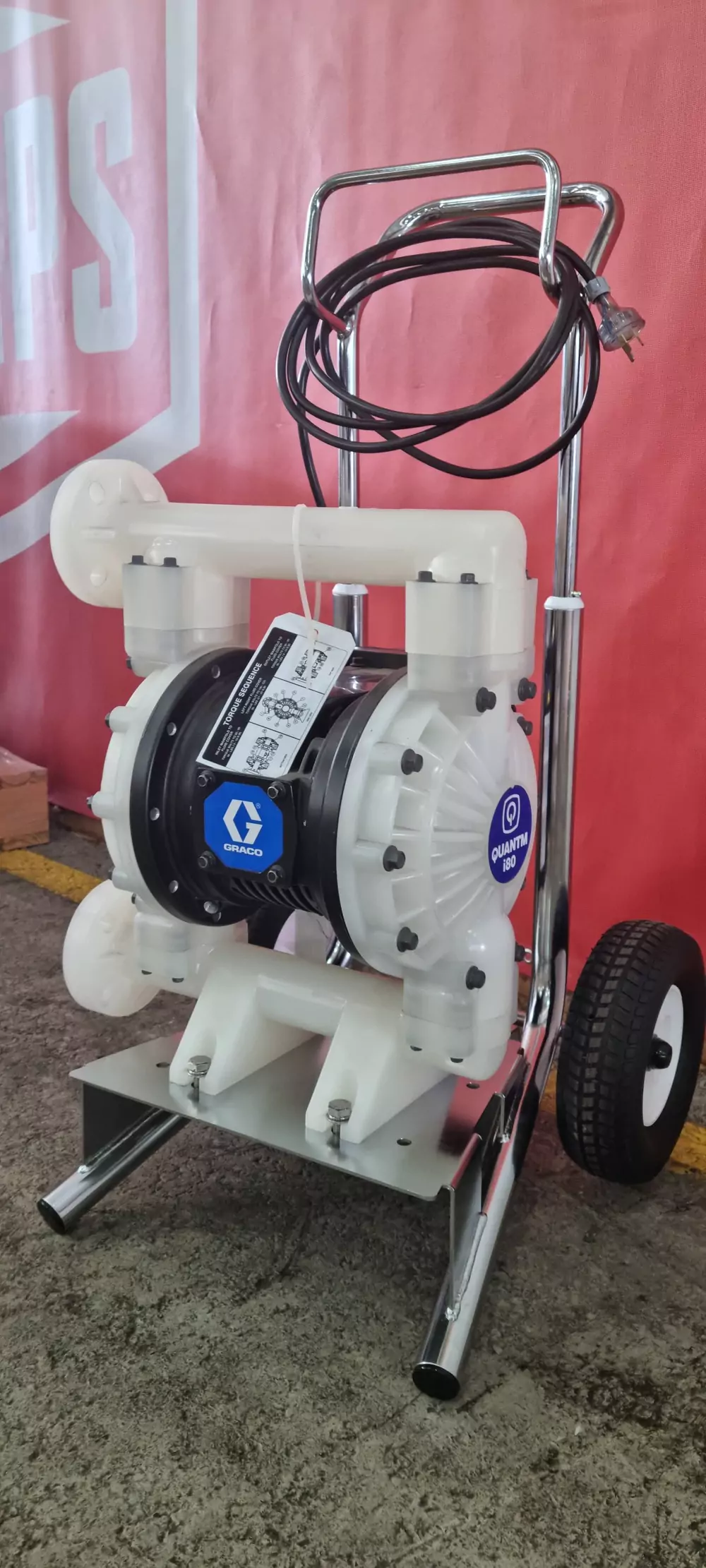 Portable, cart-mounted Graco QUANTM i180 EODD pump with a white polypropylene body and electric cord, highly versatile for site dewatering and general chemical transfer applications