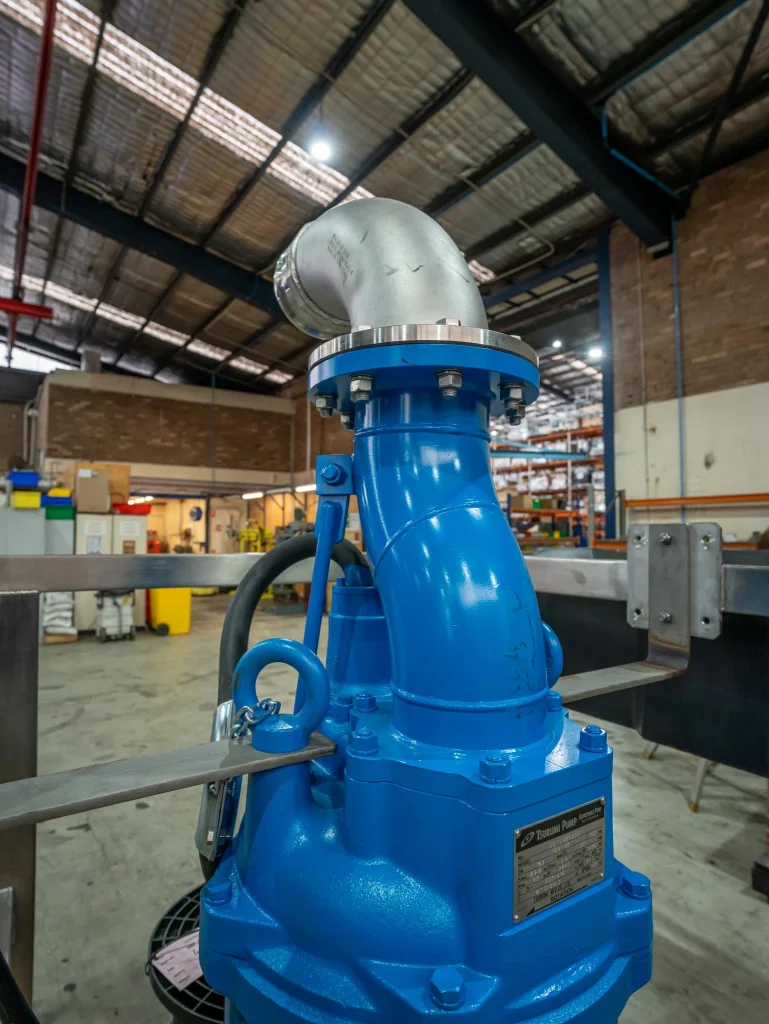 Close-up of a blue Custom-Built Tsurumi LH submersible pump, showing the heavy-duty discharge elbow; engineered for high-head dewatering and mine water applications