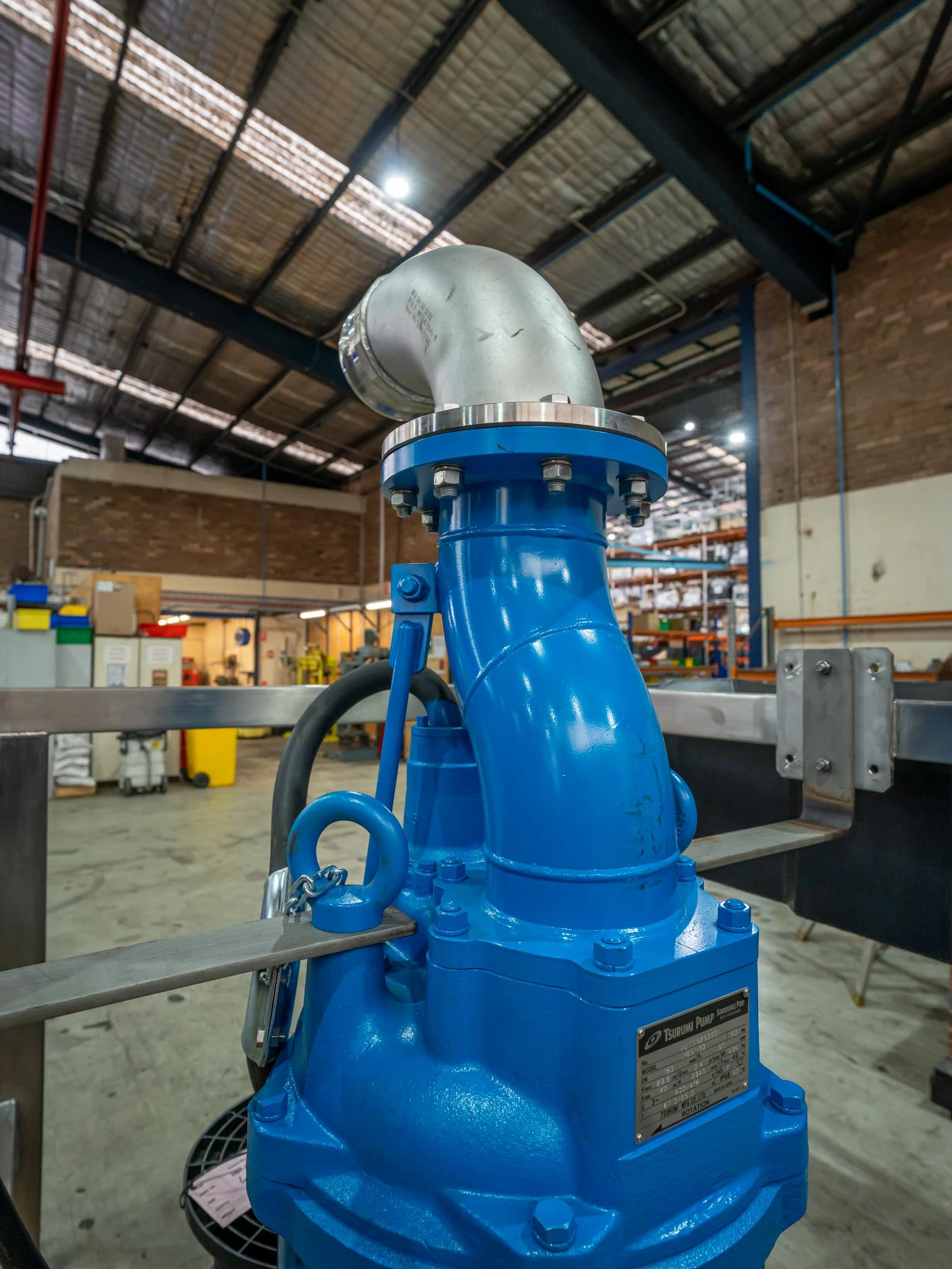 Close-up of a blue Custom-Built Tsurumi LH submersible pump, showing the heavy-duty discharge elbow; engineered for high-head dewatering and mine water applications