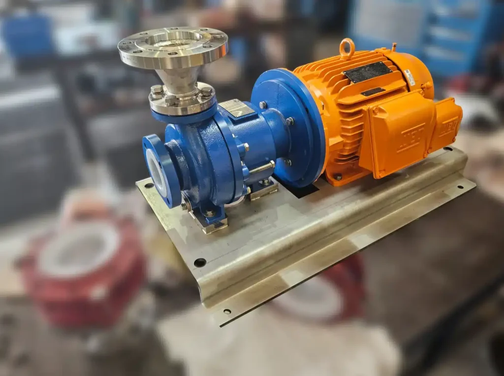 Blue pump coupled to an orange electric motor in a workshop