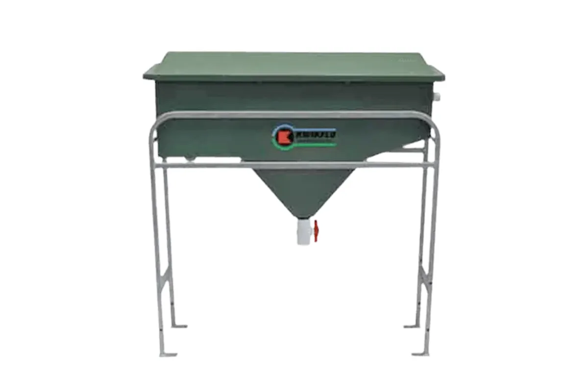 Green oil-water separator tank on metal legs.