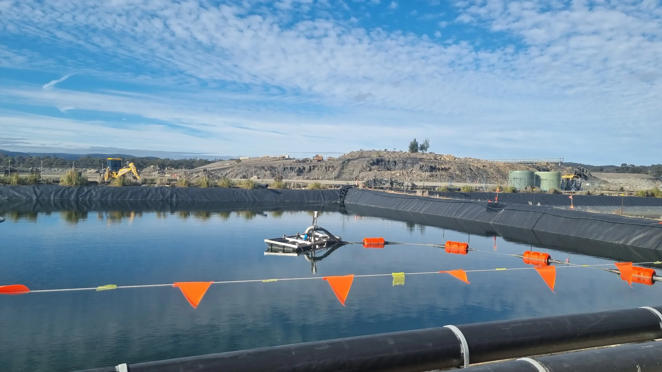 Wide view of a mine dewatering site and water pond