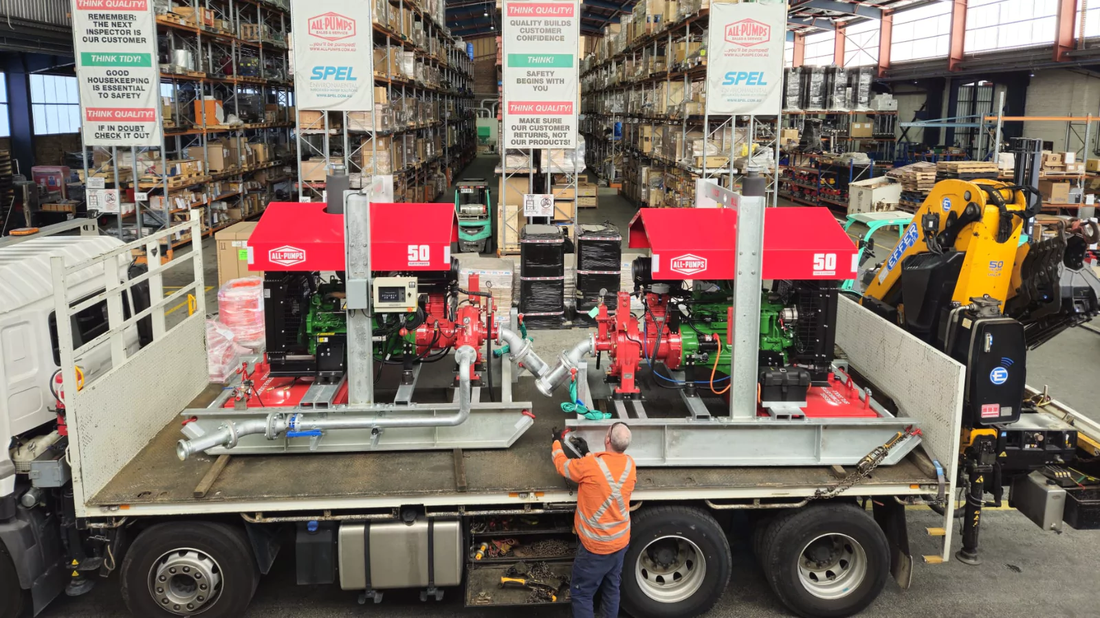 Red custom dewatering pump units in a workshop