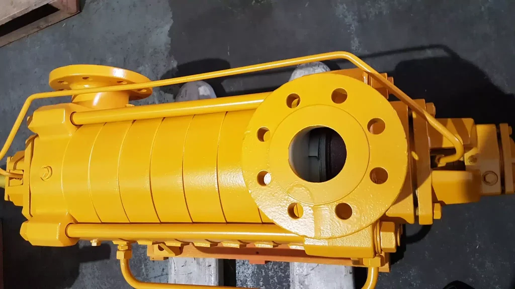 Yellow mining pump installation with guard rails
