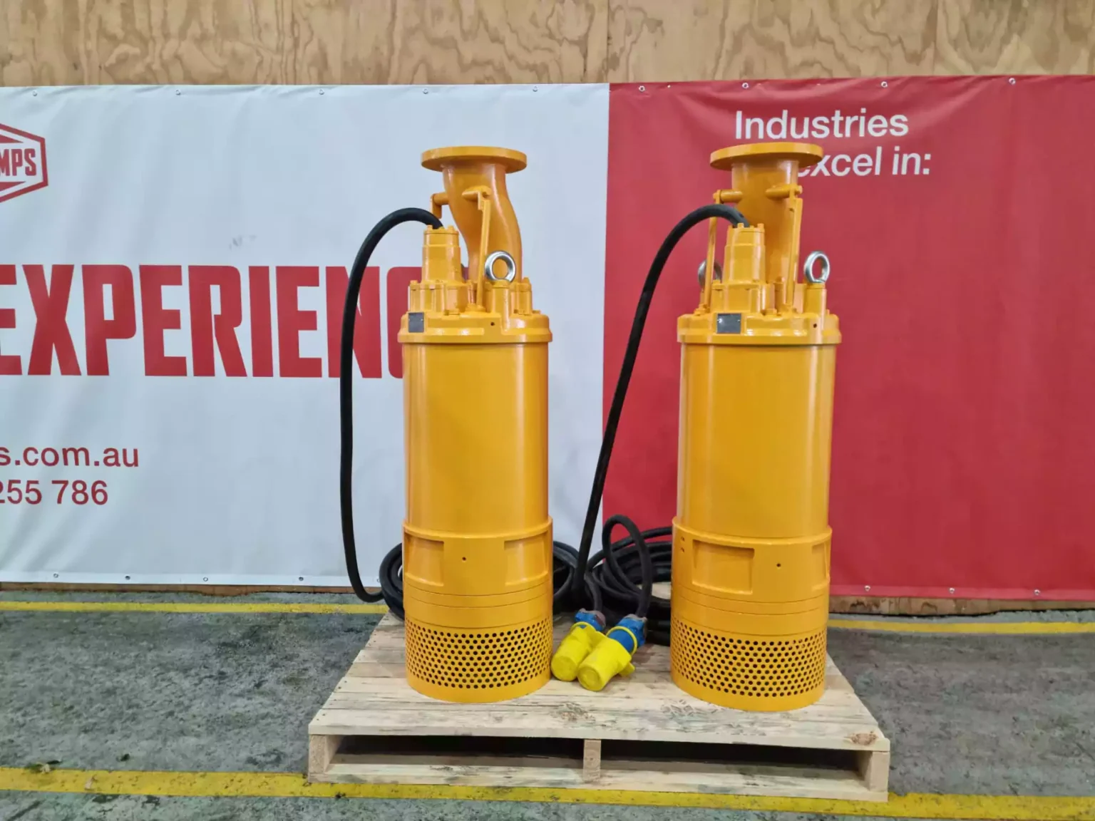 Two tall yellow Tsurumi mine dewatering pumps