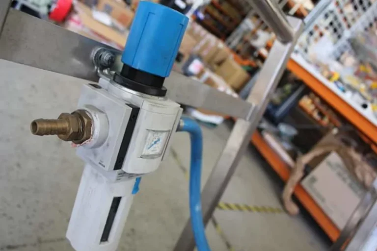 Blue component attached to white pump equipment