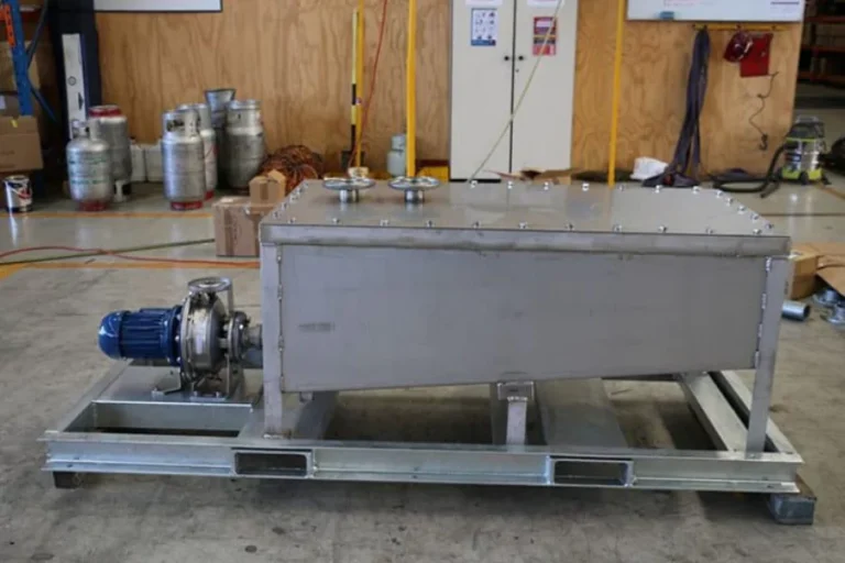 Grey rectangular industrial tank at a worksite
