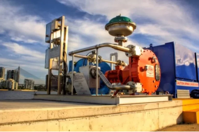Blue pump and orange coupling beside a control panel
