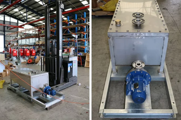 Grey industrial tank and blue pump in a workshop
